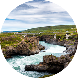 river-from-godafoss-falls-akureyri-iceland-surrounded-by-huge-rocks-concrete-bridge